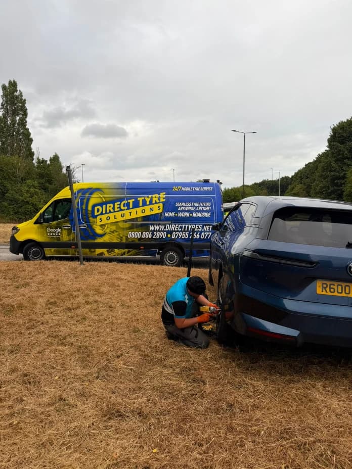 Emergency roadside mobile fitting van on UK highway hard shoulder